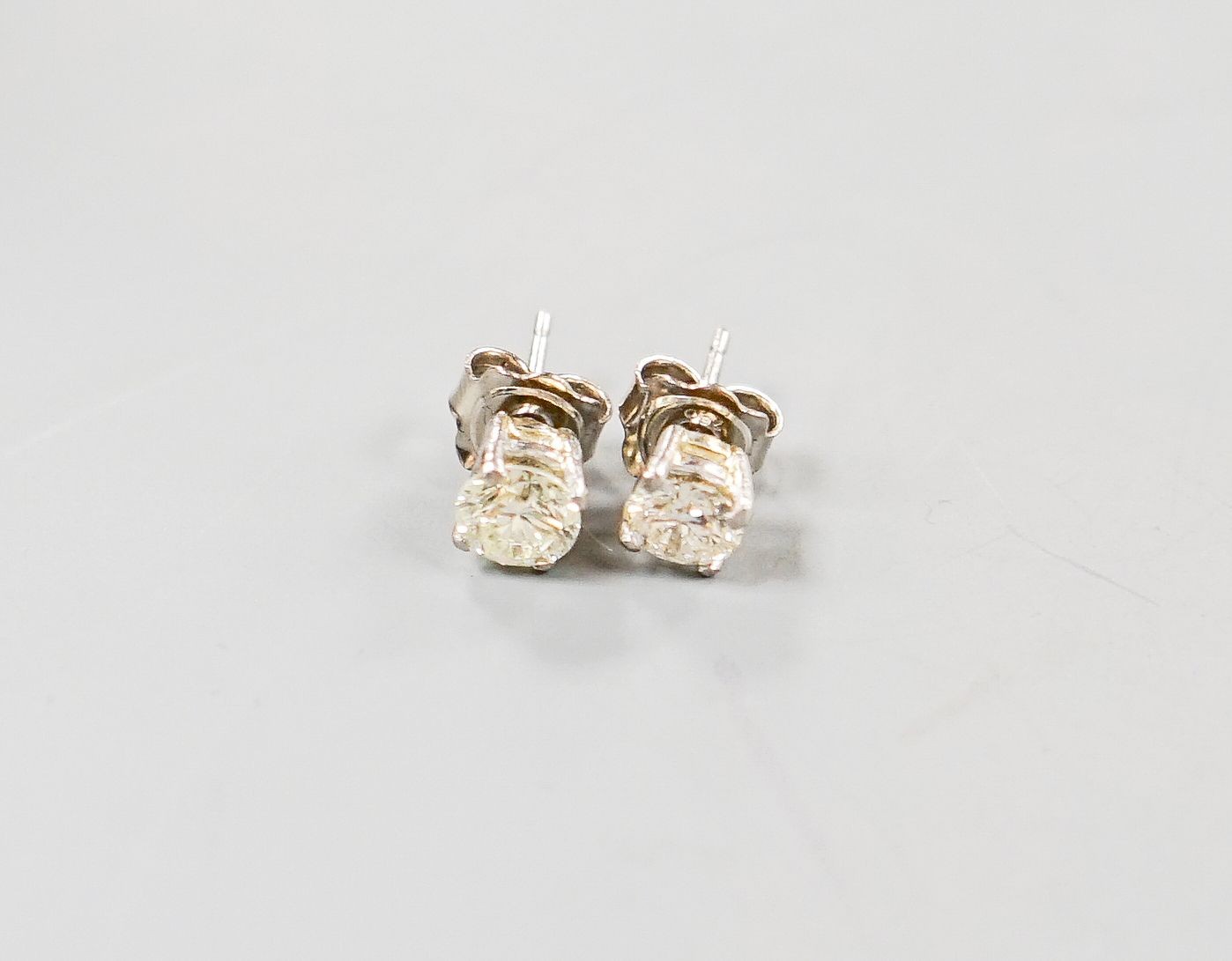 A pair of 750 white metal and solitaire diamond ear studs, gross weight 2.3 grams